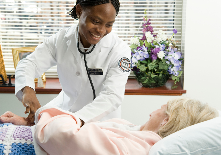 A nursing student examines a patient