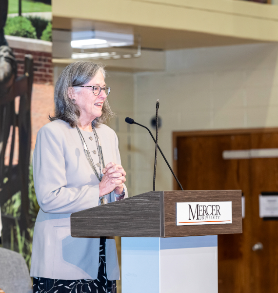 Female professor speaking at a podium