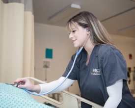 female nursing student listening for a heartbeat