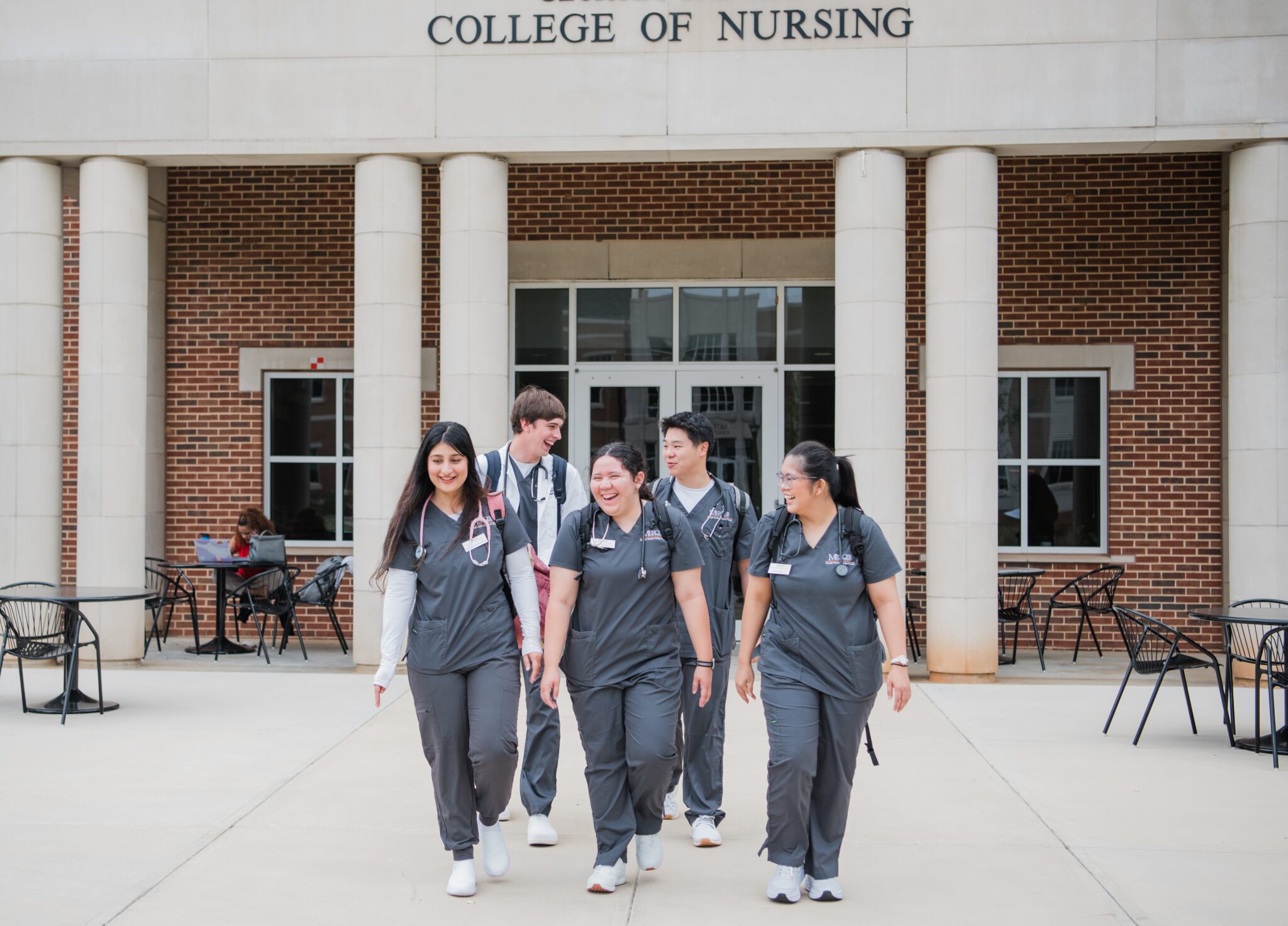 group of nursing students walking together in front of the nursing building