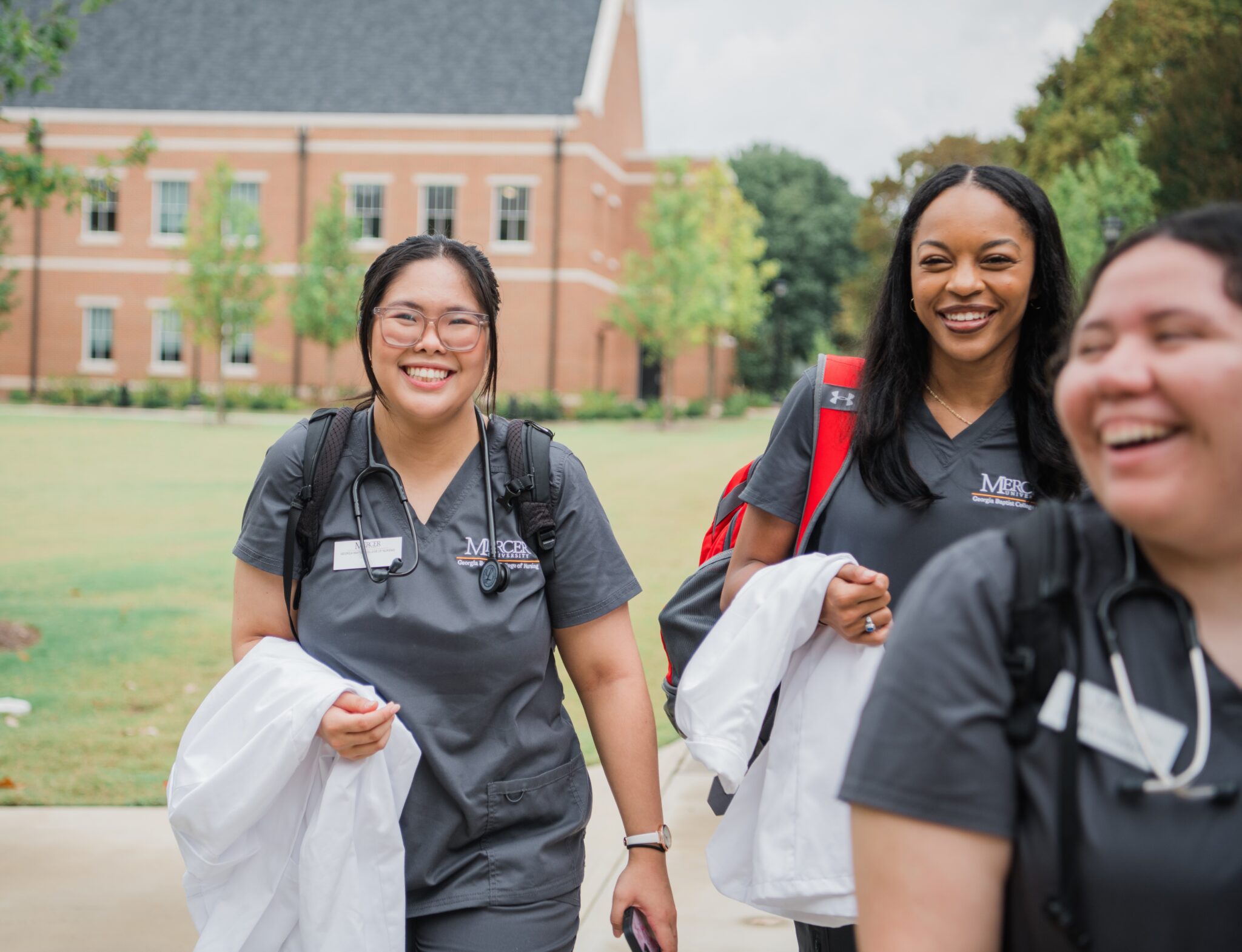 three female nursing students walking together and smiling