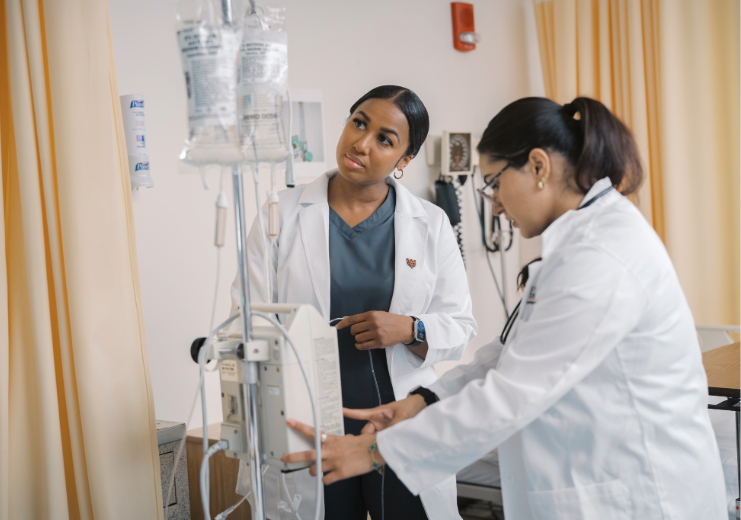 two female nursing students setting up an IV