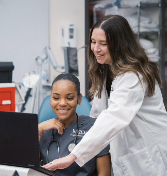nursing professor helping a nursing student