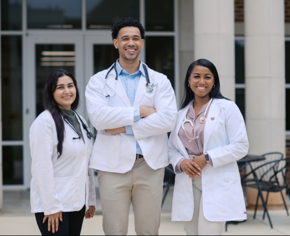 three nursing grad students standing outside together